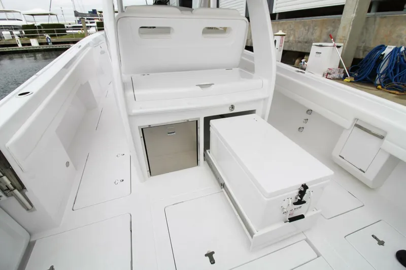  Yacht Photos Pics 2024 Intrepid 375 Nomad SE boat interior with storage compartments and seating.