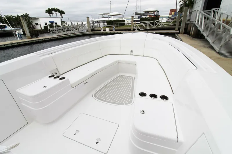  Yacht Photos Pics 2024 Intrepid 375 Nomad SE boat with spacious seating and sleek design at a marina.