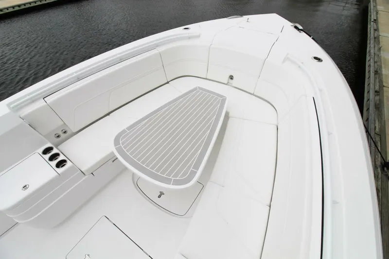  Yacht Photos Pics 2024 Intrepid 375 Nomad SE boat interior with sleek seating and table design.
