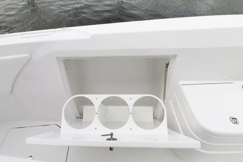  Yacht Photos Pics 2024 Intrepid 375 Nomad SE boat storage compartment with cup holders, open on deck.