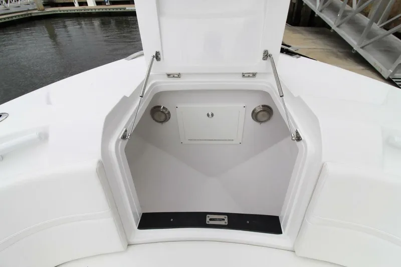  Yacht Photos Pics 2024 Intrepid 375 Nomad SE boat storage compartment open, showcasing spacious interior design.