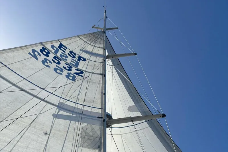 Sv Magi Yacht Photos Pics Sail of 2000 X-Yachts 442 MK II against clear blue sky.