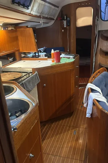 Sv Magi Yacht Photos Pics Interior of 2000 X-Yachts 442 MK II sailboat with wooden cabinetry and cozy layout.