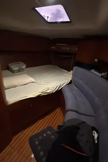 Sv Magi Yacht Photos Pics Interior cabin of 2000 X-Yachts 442 MK II with bed and seating area.