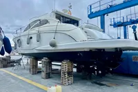 Astondoa 53 Open 2007 yacht on dry dock, supported by wooden blocks.