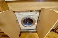 Built-in washing machine on 2007 Astondoa 53 Open yacht, wooden cabinetry.