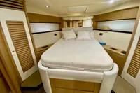 Luxurious cabin interior of 2007 Astondoa 53 Open yacht with cozy bed and wooden accents.
