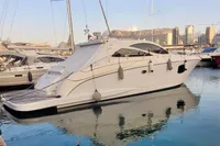 2007 Astondoa 53 Open yacht docked in a marina, reflecting on calm water.