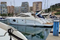 2007 Astondoa 53 Open yacht docked in a marina with cityscape background.