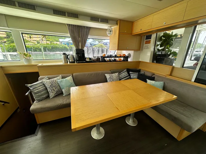  Yacht Photos Pics Interior of 2017 Lagoon 52 F yacht with cozy seating and dining area.