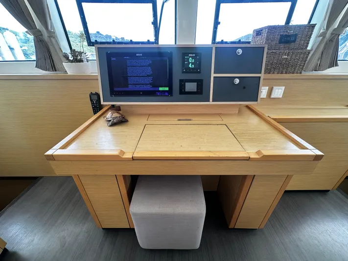  Yacht Photos Pics Navigation station inside 2017 Lagoon 52 F yacht with modern control panel and wooden desk.