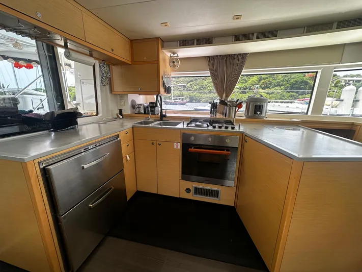  Yacht Photos Pics Modern kitchen interior of 2017 Lagoon 52 F yacht with stainless steel appliances.