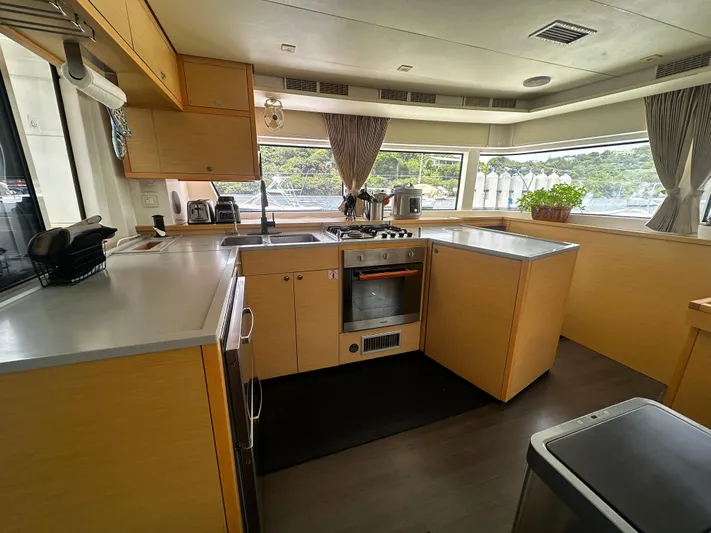  Yacht Photos Pics Spacious kitchen interior of 2017 Lagoon 52 F yacht with modern appliances and large windows.