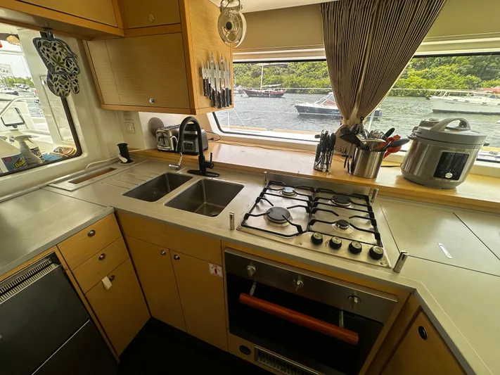  Yacht Photos Pics Modern kitchen in 2017 Lagoon 52 F yacht with stove, sink, and scenic window view.