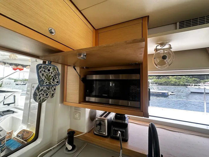  Yacht Photos Pics Interior of 2017 Lagoon 52 F yacht kitchen with microwave and appliances.