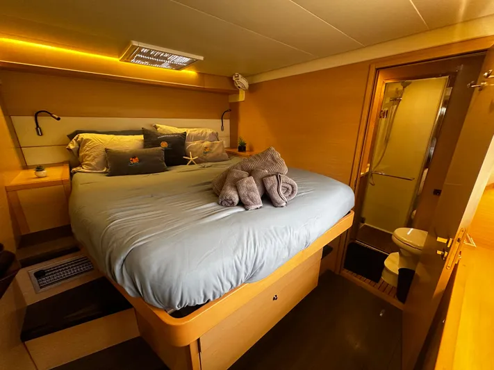  Yacht Photos Pics Luxurious cabin interior of 2017 Lagoon 52 F yacht with cozy bed and ensuite bathroom.