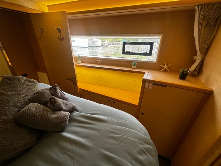  Yacht Photos Pics Cozy cabin interior of 2017 Lagoon 52 F yacht with bed, window, and decor.