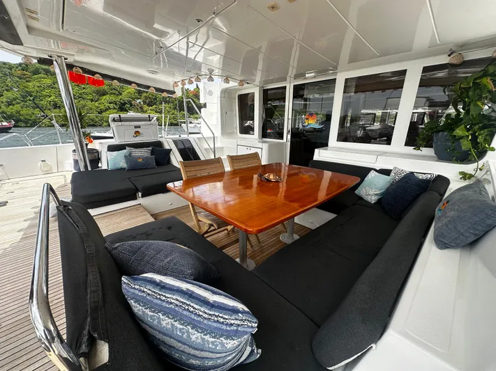  Yacht Photos Pics Spacious outdoor seating on 2017 Lagoon 52 F yacht with wooden table and cushions.