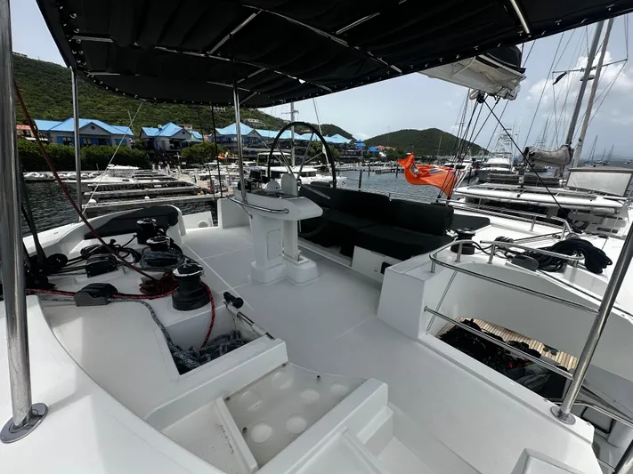  Yacht Photos Pics 2017 Lagoon 52 F yacht deck with helm, moored in scenic marina.