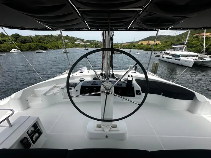  Yacht Photos Pics Steering wheel of 2017 Lagoon 52 F yacht, docked in a scenic marina.