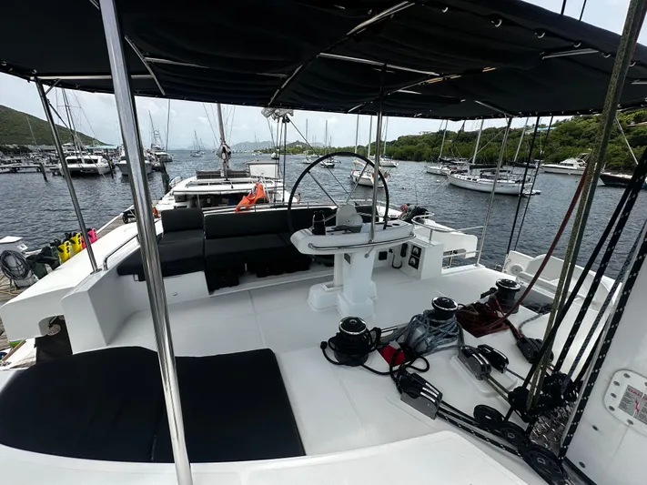  Yacht Photos Pics Lagoon 52 F catamaran cockpit, 2017 model, docked in a marina with surrounding sailboats.