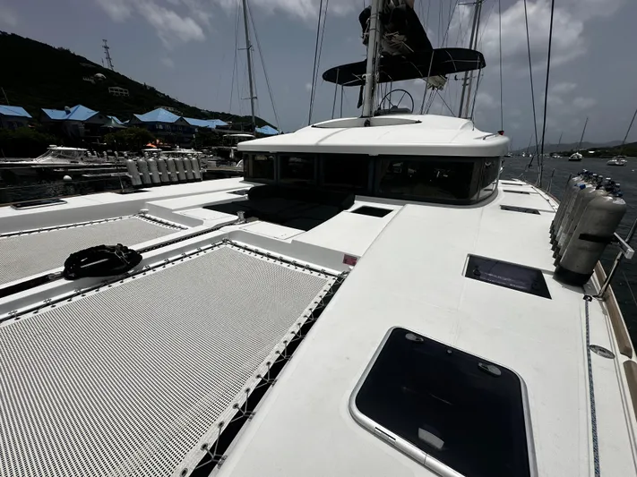  Yacht Photos Pics 2017 Lagoon 52 F catamaran docked, featuring spacious deck and netting.