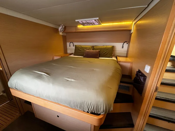  Yacht Photos Pics Luxurious cabin interior of 2017 Lagoon 52 F yacht with cozy bed and ambient lighting.