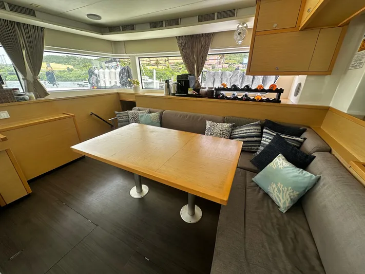  Yacht Photos Pics Interior of 2017 Lagoon 52 F yacht with cozy seating and wooden table.