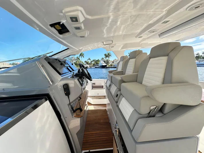  Yacht Photos Pics Interior of 2018 Azimut Verve 40 yacht with luxurious seating and helm, overlooking water.