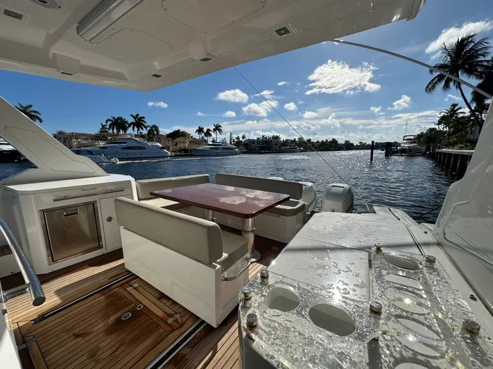  Yacht Photos Pics 2018 Azimut Verve 40 yacht deck with seating, table, and waterfront view.