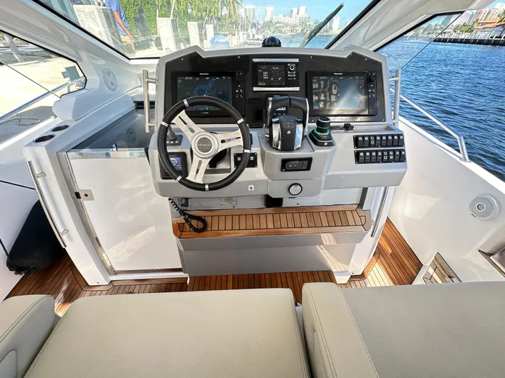  Yacht Photos Pics Helm of 2018 Azimut Verve 40 yacht with modern controls and wooden accents.
