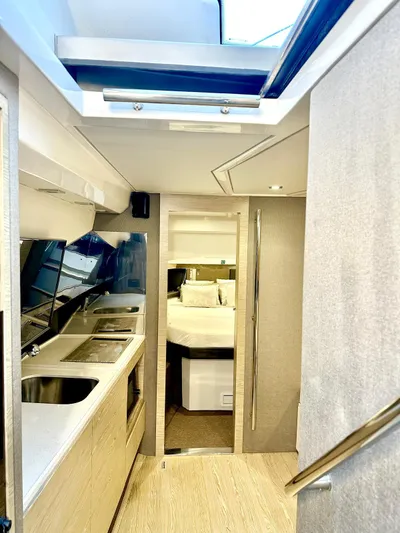  Yacht Photos Pics Interior of 2018 Azimut Verve 40 yacht, featuring modern kitchen and cozy sleeping area.