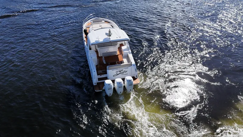  Yacht Photos Pics 2018 Azimut Verve 40 yacht cruising on open water, rear view.
