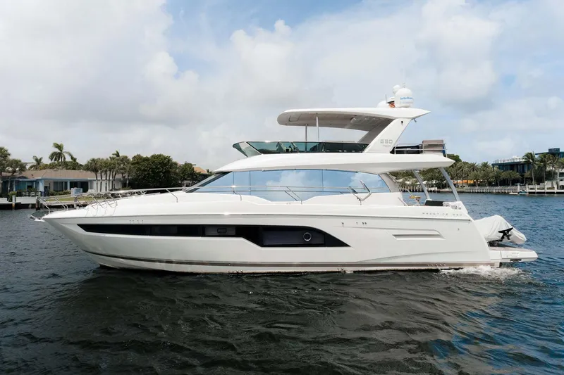 No Rush Yacht Photos Pics 2018 Prestige 630 yacht cruising on a calm waterway under a partly cloudy sky.