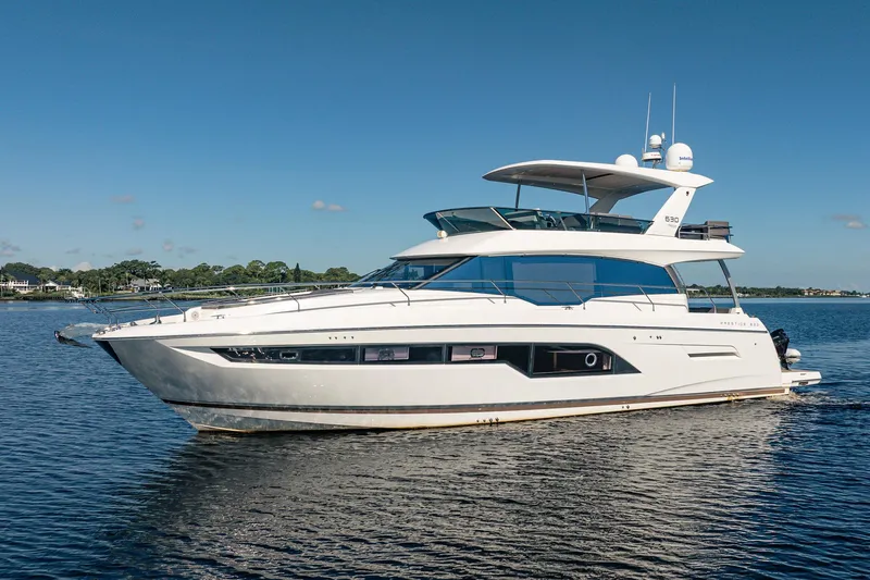 No Rush Yacht Photos Pics Luxurious 2018 Prestige 630 yacht cruising on calm waters under a clear blue sky.