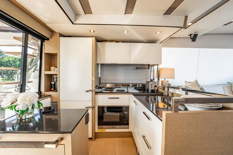 No Rush Yacht Photos Pics Luxurious kitchen interior of 2018 Prestige 630 yacht with modern appliances and elegant decor.