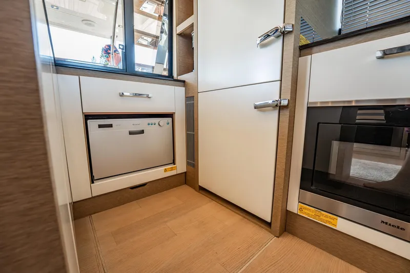 No Rush Yacht Photos Pics Modern kitchen interior in 2018 Prestige 630 yacht, featuring sleek appliances and wood flooring.