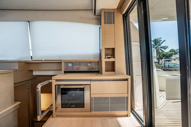 No Rush Yacht Photos Pics Interior of 2018 Prestige 630 yacht with modern kitchen and outdoor view.