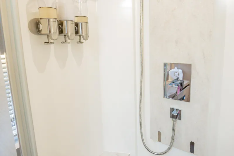 No Rush Yacht Photos Pics Modern shower with chrome fixtures and three soap dispensers in a 2018 Prestige 630 yacht.