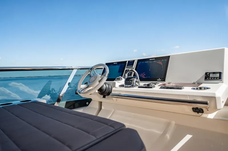 No Rush Yacht Photos Pics Cockpit of 2018 Prestige 630 yacht with navigation screens and steering wheel.