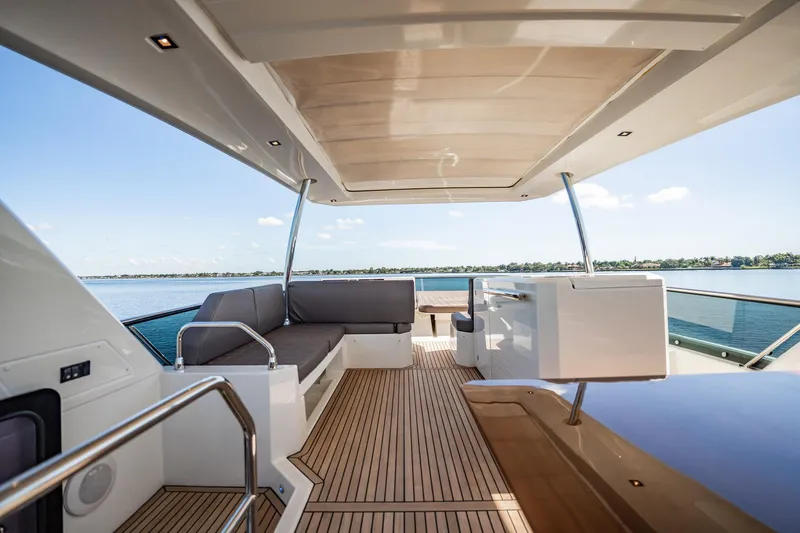 No Rush Yacht Photos Pics Luxurious 2018 Prestige 630 yacht deck with seating, overlooking serene waters.