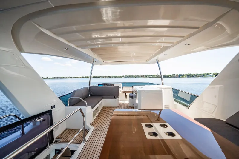 No Rush Yacht Photos Pics Luxurious 2018 Prestige 630 yacht interior with elegant seating and scenic water view.