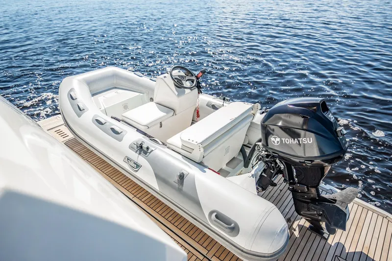 No Rush Yacht Photos Pics Inflatable boat with Tohatsu motor on Prestige 630 yacht, 2018 model, docked on water.