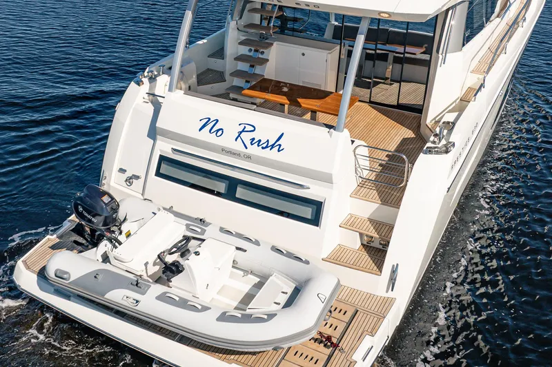 No Rush Yacht Photos Pics Luxury 2018 Prestige 630 yacht with tender, named "No Rush," cruising on water.