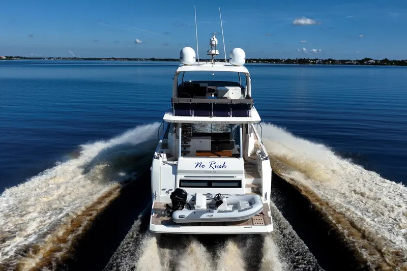 No Rush Yacht Photos Pics 2018 Prestige 630 yacht cruising on calm waters, rear view.