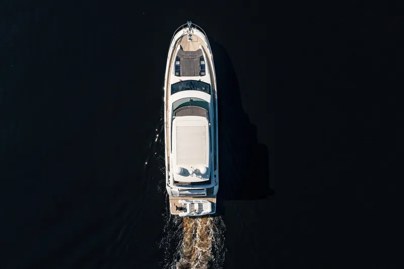 No Rush Yacht Photos Pics Aerial view of 2018 Prestige 630 yacht cruising on dark water.