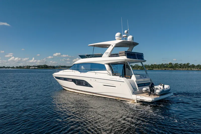 No Rush Yacht Photos Pics Luxury 2018 Prestige 630 yacht cruising on a serene blue lake under clear skies.