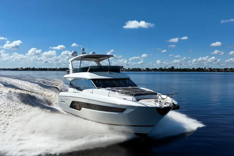 No Rush Yacht Photos Pics Luxurious 2018 Prestige 630 yacht cruising on a sunny day, creating a dynamic water trail.
