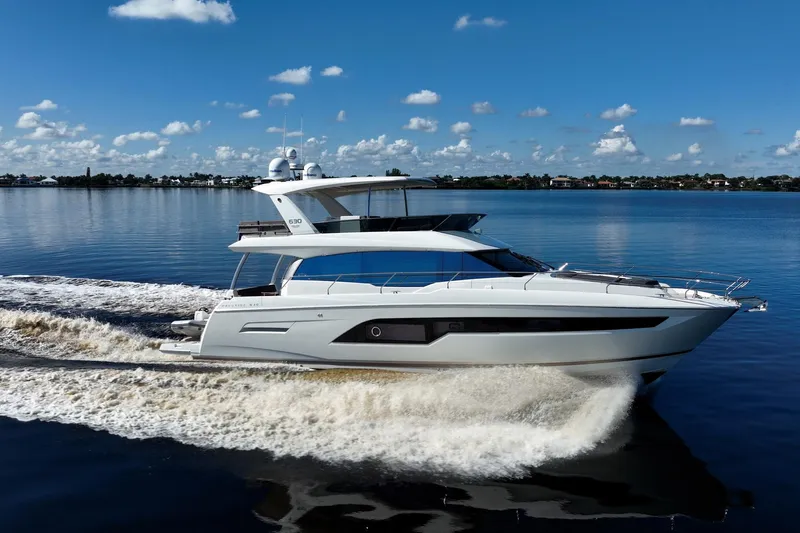 No Rush Yacht Photos Pics Luxury 2018 Prestige 630 yacht cruising on calm waters under a clear blue sky.