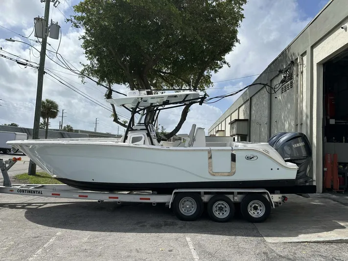  Yacht Photos Pics 2022 Sea Fox 288 Commander boat on trailer, parked outside a building.